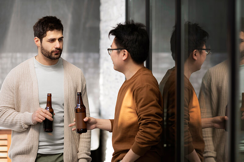 A photo of 2 men with beers