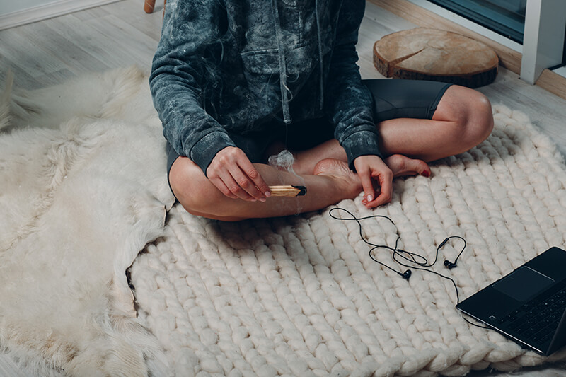 A photo of a man sitting with his legs crossed