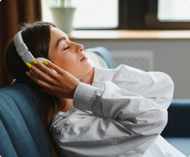 A photo of a woman listening to headphones