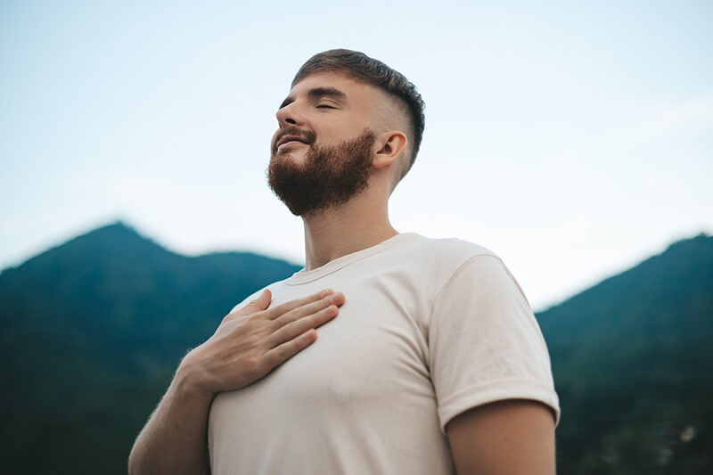 Photo of a happy handsome man relaxing in nature