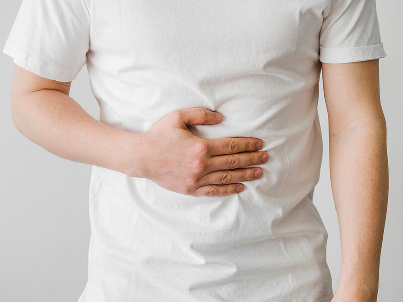 Photo of a man with his hand over his stomach