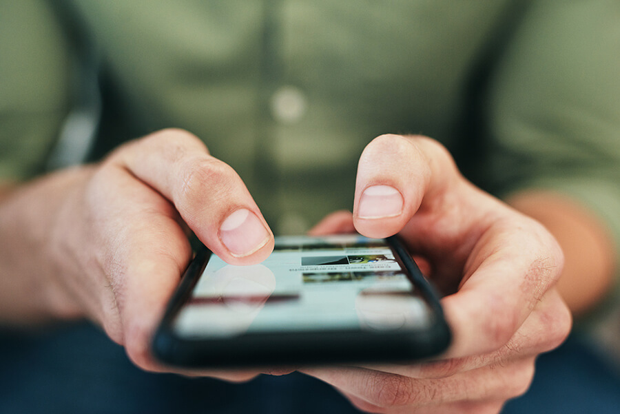 Photo of a man using is phone