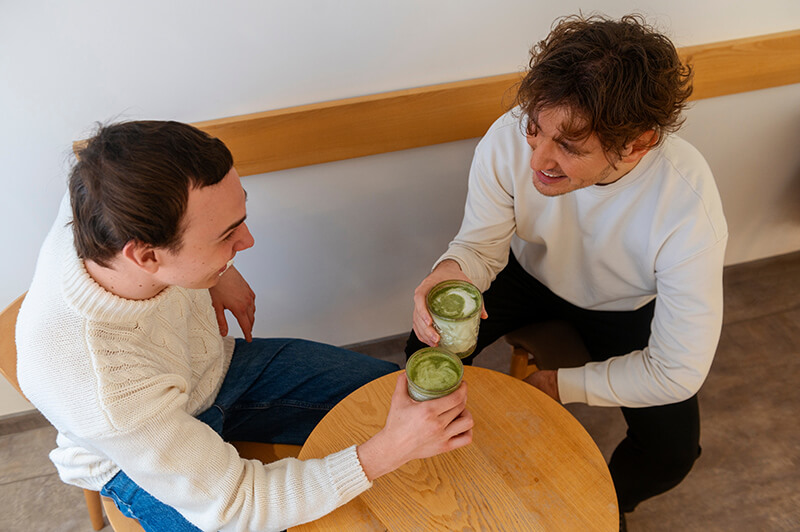 A photo of two friends drinking tea