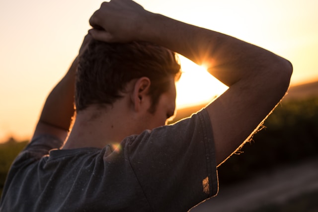 A photo of a person self reflecting in the sunset