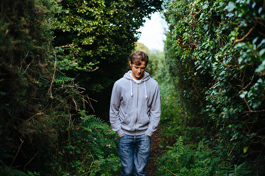 A photo of a man walking through a forest