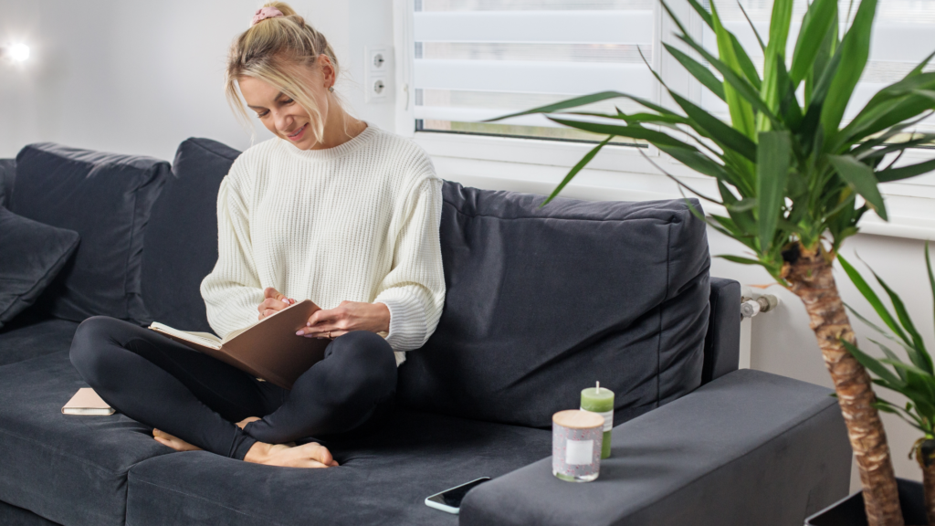 Happy woman journaling peacefully with UM.app to build resilience and manage stress without alcohol