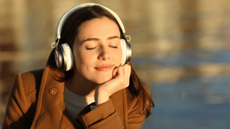 Serene young woman in meditation pose wearing headphones, eyes closed in calm relaxation, symbolizing neuroplasticity and gentle suggestion to lower alcohol urges via UM.app