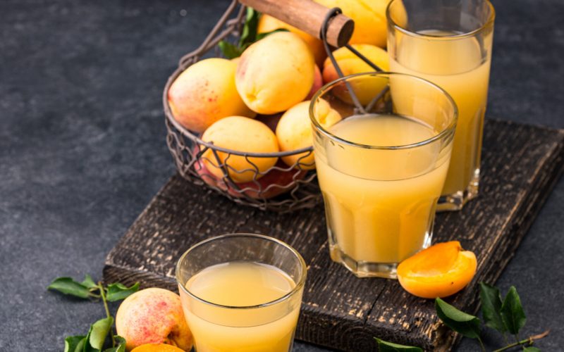 Apricot juice in glass. Healthy vitamin summer drink