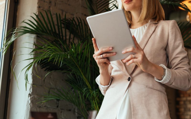 Cropped shot of a young businesswoman using a digital tablet in a coffee shop